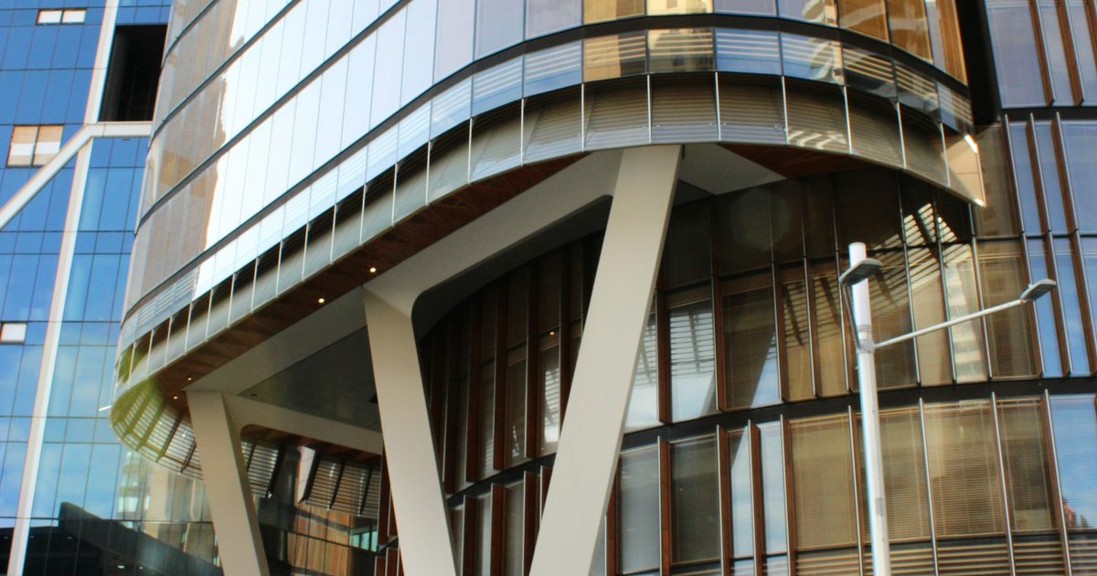 Glass commercial facade with structural columns in Sydney; representative property photograph.